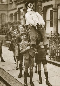 Children carrying a Guy Fawkes on Bonfire Night by English Photographer